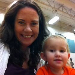 Mother reading to daughter at Books in the Courtyard.